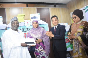 Minister of State for Education, Prof. Suwaiba Ahmad (2nd L); presenting ICT Equipment to the Vice chancellor, Federal Provost College of Education, Kontagora, Niger State, Prof. Faruk Haruna (L); during the handing over of ICT equipment to 15 Federal and State Colleges of Education by the Federal Ministry of Education (FME) in collaboration with the Government of Japan and UNESCO-IICBA in Abuja on Tuesday (2/6/26). With them are: Director of the Colleges of Education, FME, Dr Uchenna Mba (R) and Charge D'affaires, Embassy of Japan, Mr Hitoshi Kozaki.0026/TUE/JUNE/2/2026/Deborah Bada/NAN 
