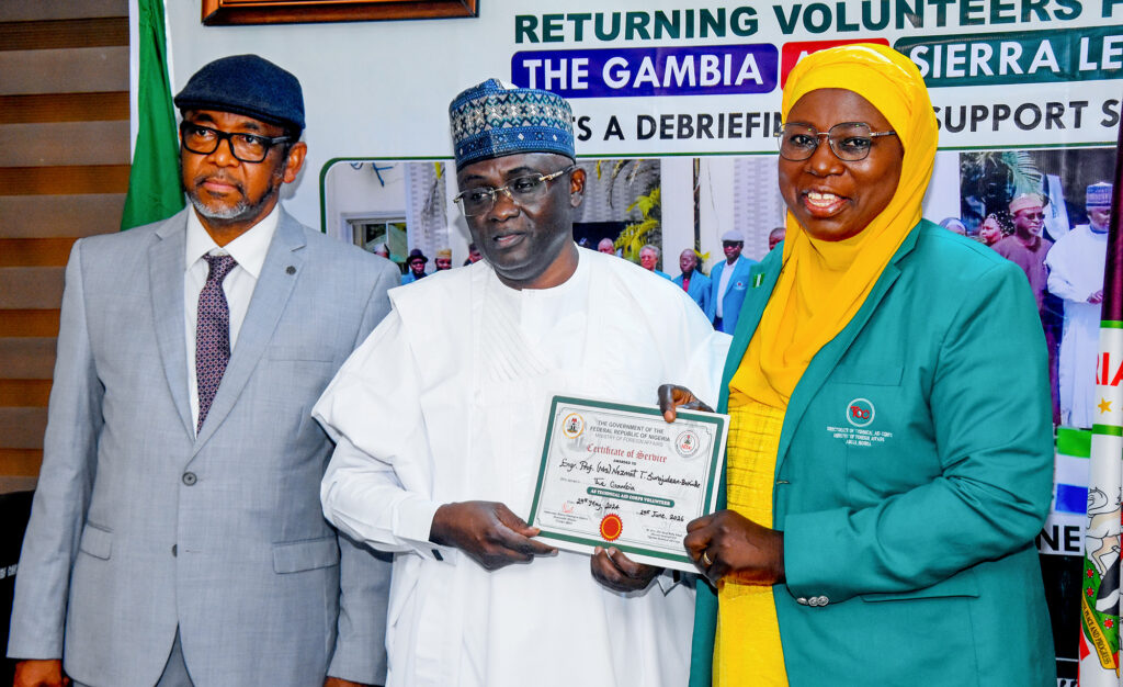 NAN-PHOTO: NTAC  debriefs issues completion certificate to returning volunteers from Gambia and Sierra Leone in Abuja